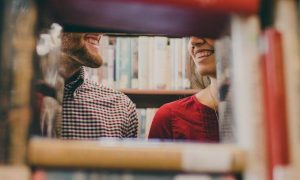 couple faces smiling in bookstore