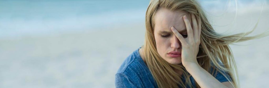 woman hand in face feeling sad stressed