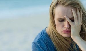 woman hand in face feeling sad stressed
