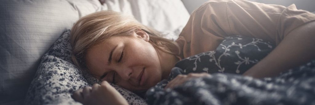 woman sleeping tightly well on bed