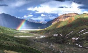 breathtaking mountainous scene rainbow sunny blue sky