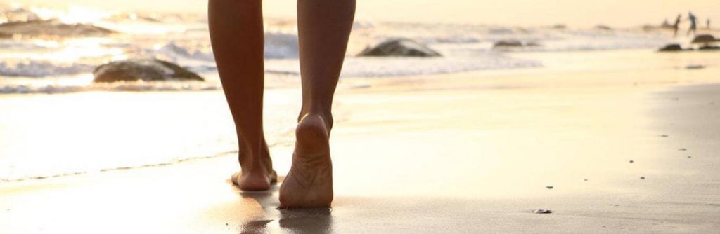legs walking on sand on beach