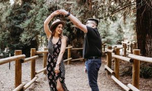couple happily dance aerobics in forest