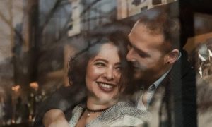 couple happily hugs smiling while man kissing girlfriend