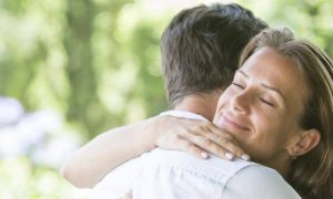 woman satisfied hugging boyfriend