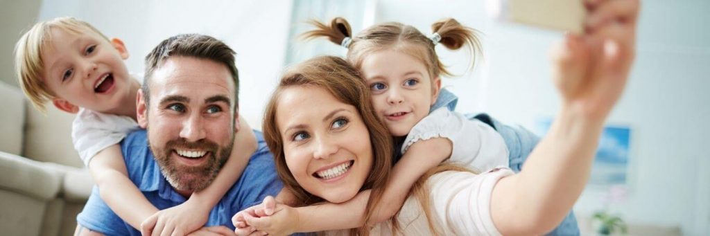 happy family smiles taking selfie in living room