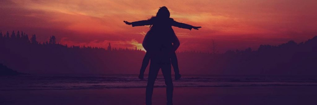 woman shadow raising hand in red sunset sky