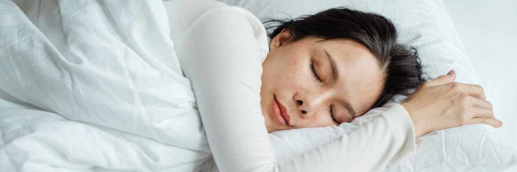 woman sleeping taking nap nicely deeply on pillow blanket