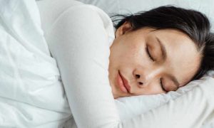 woman sleeping taking nap nicely deeply on pillow blanket